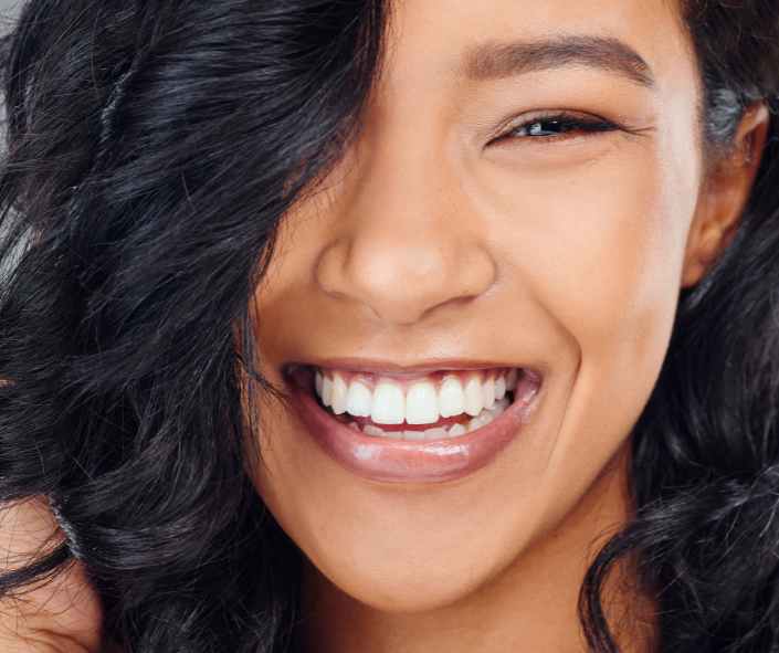 Woman holding Invisalign aligner